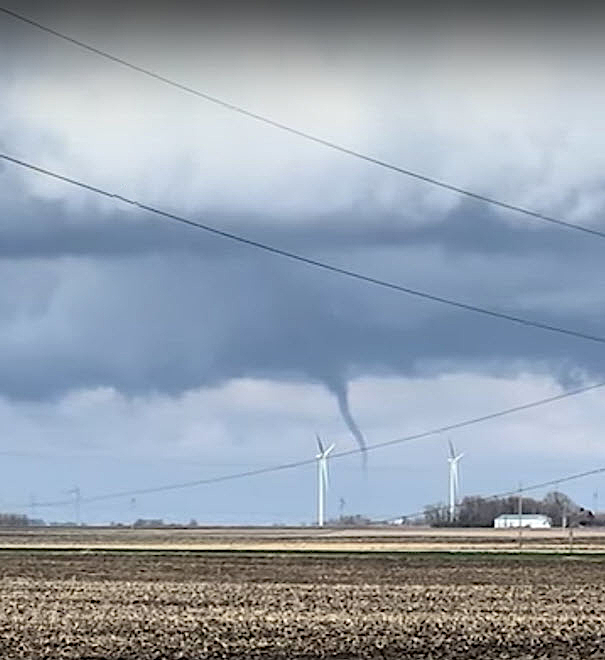 A small tornado touches down in an Iowa wind farm.